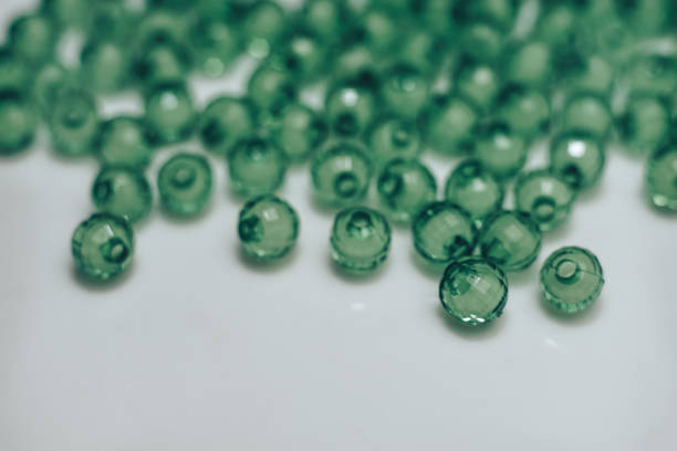 istock Green glass beads on a white background. Macro view. 1142457781