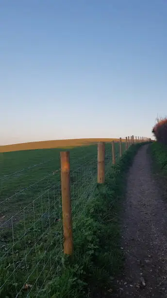 Footpath next to wire fencing on the Sussex Southdowns in Southern England.
