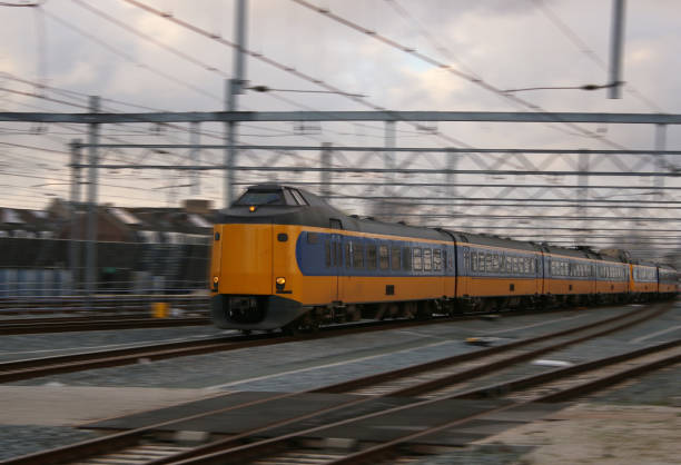 istock yellow train or intercity driving very quick with motion blur, scenic wallpaper 1142459185
