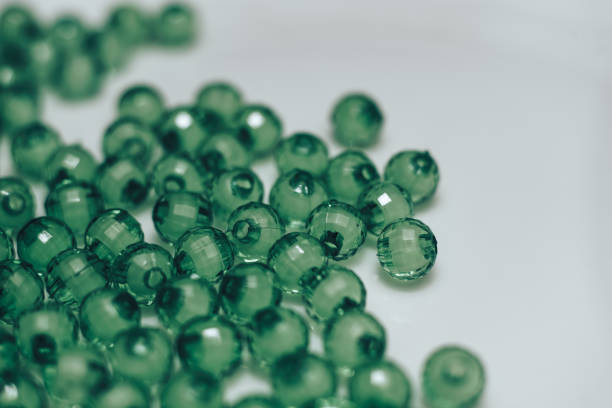 istock Green glass beads on a white background. Macro view. 1142461153