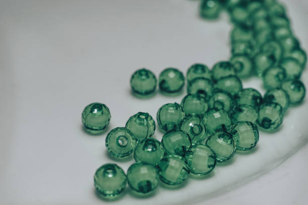 istock Green glass beads on a white background. Macro view. 1142462129