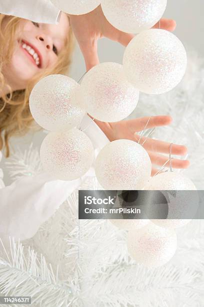 Hanging Baubles On Christmas Tree Stock Photo - Download Image Now - Blond Hair, Child, Childhood