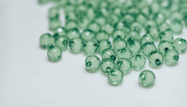 istock Green glass beads on a white background. Macro view. 1142463933