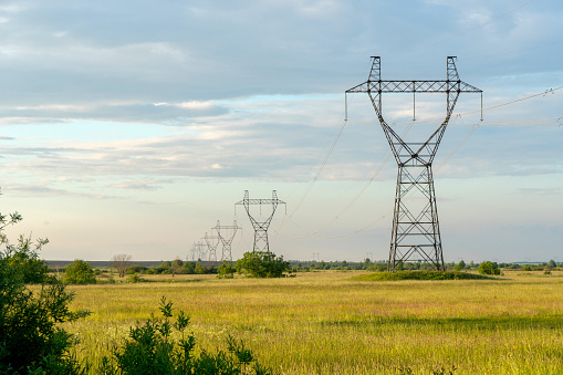 A transmission tower stands in southwestern Ontario. Overcast summer morning.