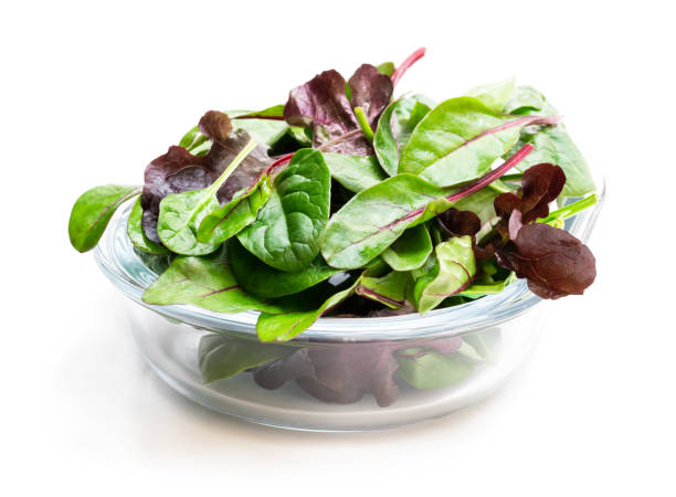 istock Mixed salad leaves in glass bowl isolated on white 1142468976