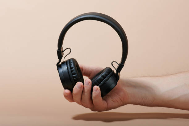 istock Wireless headphones in man hand 1142472101