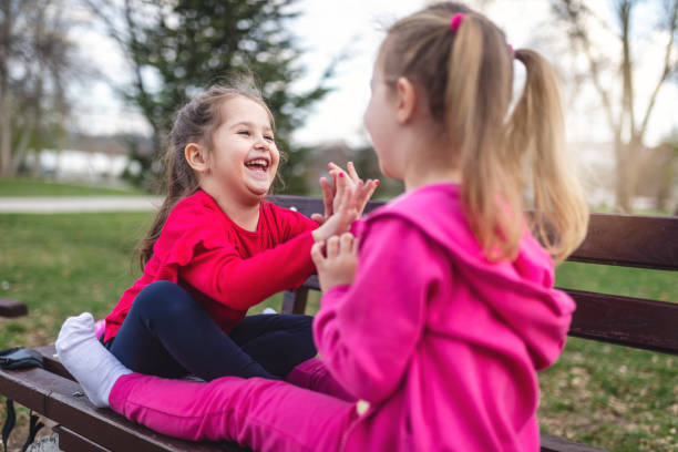 istock Cute innocent children playing at a park 1142473785