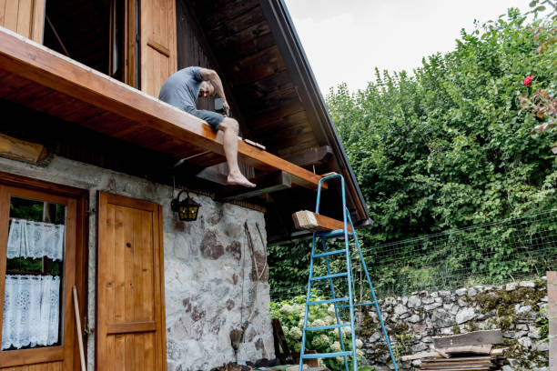 Man Using Electric Screw Drill for Fixing Wooden Plank on New House Balcony