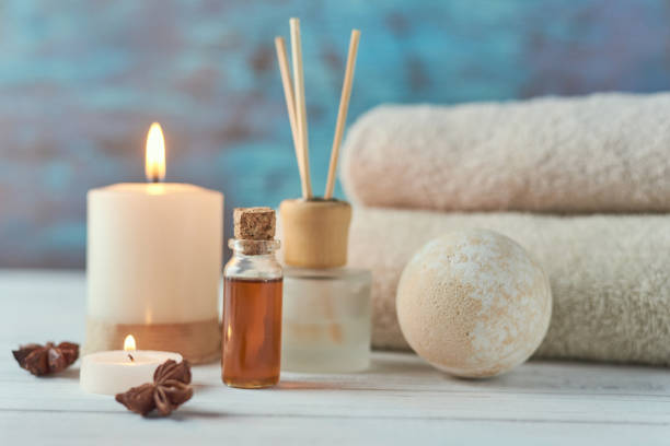 istock Towels, candle and massage oil on white table 1142479222
