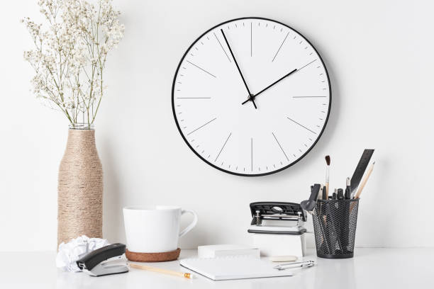 istock Office supplies and wall clock on white 1142479280