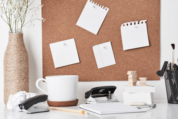 istock Cork board with office supplies on white background 1142479283