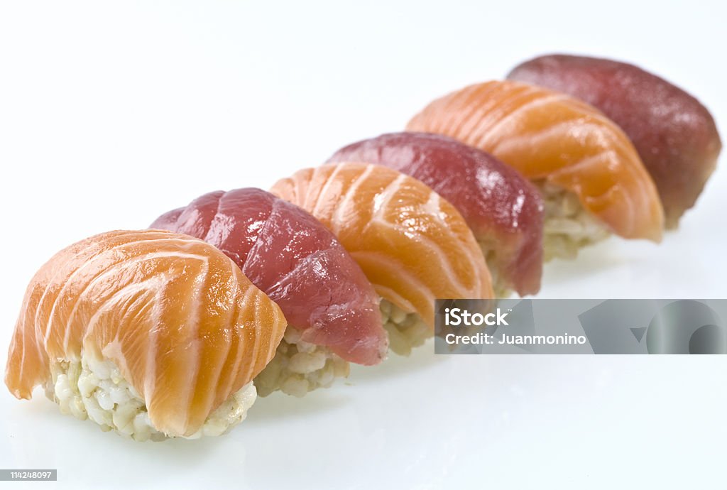 Fresh, Raw Sushi in a Row Against a White Background   Appetizer Stock Photo