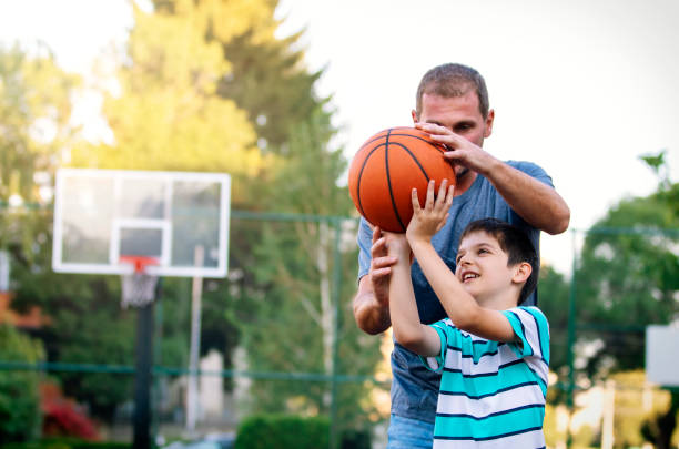 istock Morning Training. Father And Son Playing Basketball 1142482883
