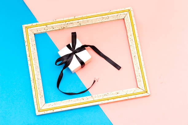 istock small gift box over frame picture isolated on colorful  background 1142482925