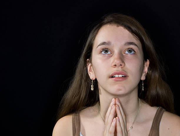 istock Little girl praying 114248309