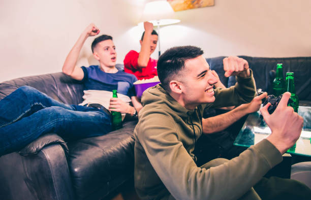 istock Excited guys play video game 1142484256
