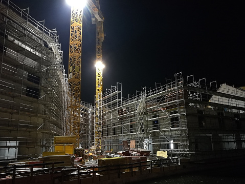 a construction site by night illuminated by floodlight.