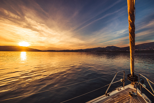 Sailing boat to the sunrise on Adriatic sea