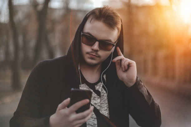 guy in glasses and hoodie walking on street. - costume mustache child disguise imagens e fotografias de stock