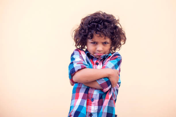 istock Sad kid with curly hair over isolated background 1142487179