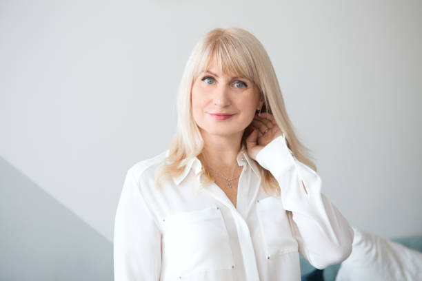 istock portrait aged blond woman smiling looking at the camera 1142487270