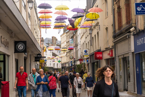 people walk along the pedestrian shopping street under the umbrellas of cherbourg. normandy france - cherbourg imagens e fotografias de stock