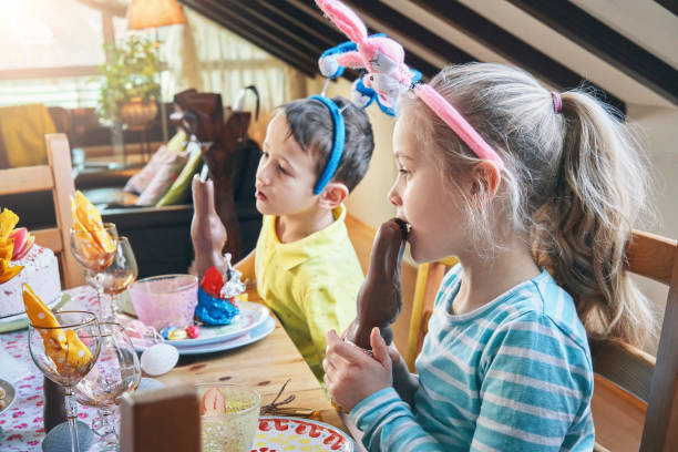 istock Little Kids Eating Chocolate Easter Bunny 1142490012
