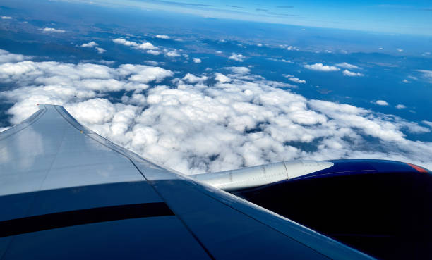 istock Blue sky and white clouds from window of aircraft flight in summer 1142492930