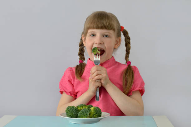 istock little girl (child, kid) loves broccoli. 1142492966