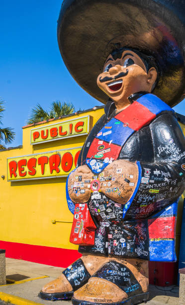Dillon, South Carolina, USA, March 23, 2019-  Wearing a huge Mexican Sombrero and a colorful serape, Pedro, the iconic symbol of the South of the Boarder rest stop along Interstate Route 95, stands outside the public restroom and is subject to the stickers and autographs of passing travellers.