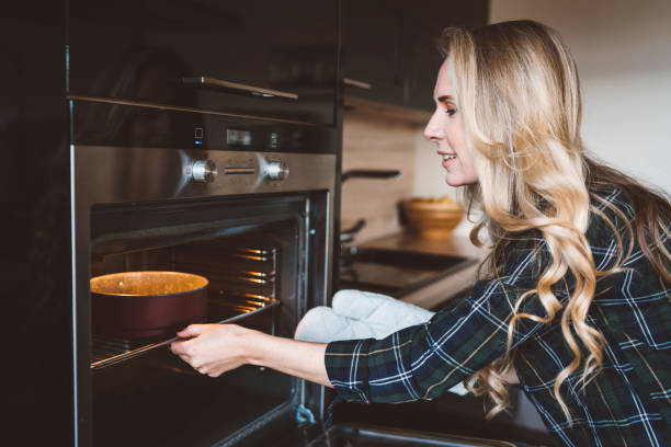 istock A female baker baking a cake in the oven 1142494438
