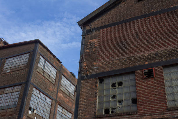 istock Two abandoned industrial buildings against a blue sky 1142494876