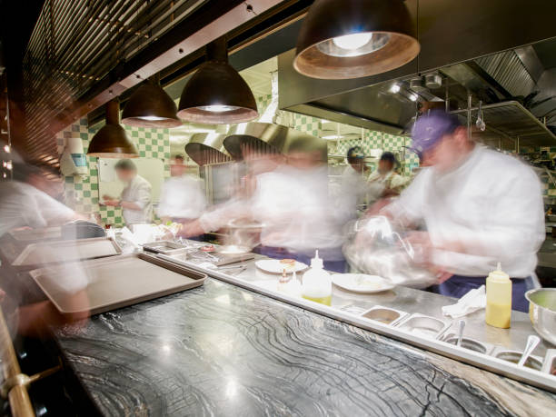 overly busy restaurant kitchen - cooking process imagens e fotografias de stock