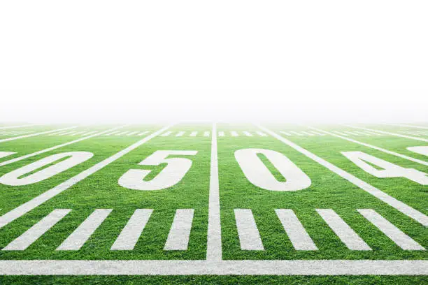 Close up of fictitious American football stadium field with yard line markings and white background for copy space. Fictitious stadium created in Photoshop.