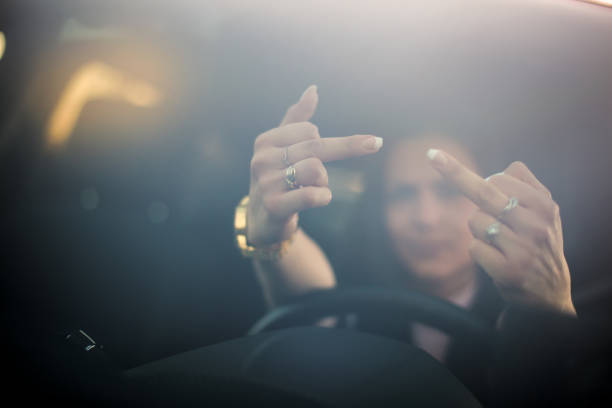 istock Angry young woman making abusive gesture on the road 1142497480