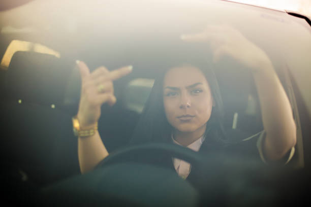 istock Angry young woman making abusive gesture on the road 1142497667
