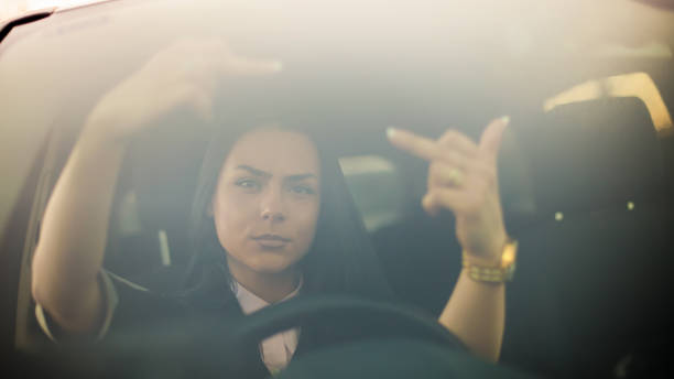 istock Angry young woman making abusive gesture on the road 1142497671