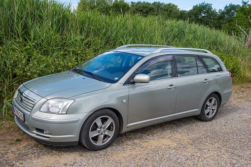 Avno Denmark - July 1. 2018: Toyota Avensis rental car parked in the nature