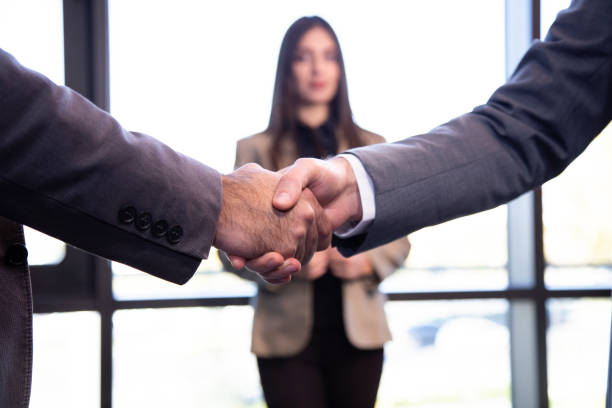 istock Two confident business man shaking hands during a meeting in the office, success, dealing, greeting and partner concept. 1142499499