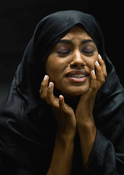 istock A woman holding her face in despair 114250322