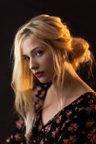 istock Attractive Young Blond Woman On Black Background 1142510672