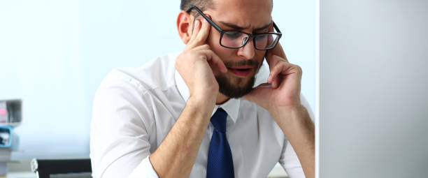 istock Tired clerk at laptop pc workplace wearing glasses 1142514181