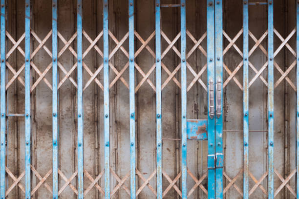 istock The rusty vintage steel shutter door with lock. 1142514596