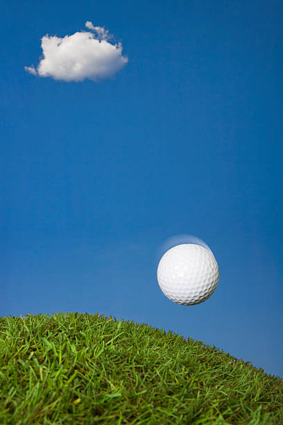 istock Golf ball mid-air landing on grass 114251528