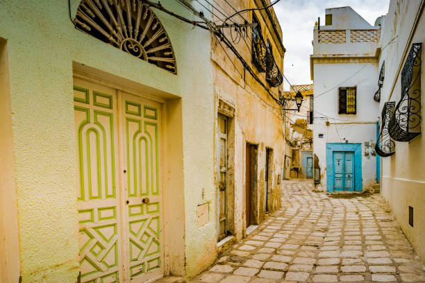 street in Medina in Sousse, Tunisia. A street in Medina in Sousse, Tunisia. Magical space of medieval town with colorful walls and stone pavement. sousse tunisia stock pictures, royalty-free photos & images