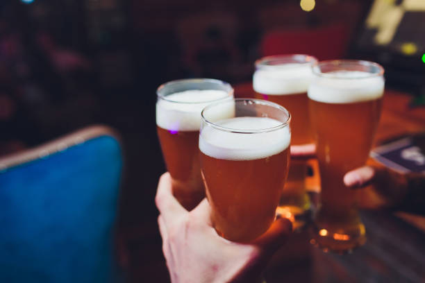 istock Barman hands pouring a lager beer in a glass. 1142516841