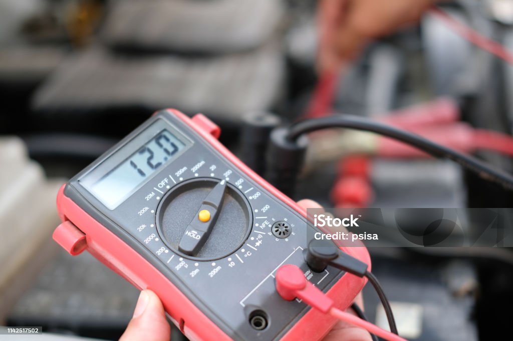 Auto Mechanic Check Car Battery Voltage By Voltmeter Multimeter Stock Photo  - Download Image Now - iStock