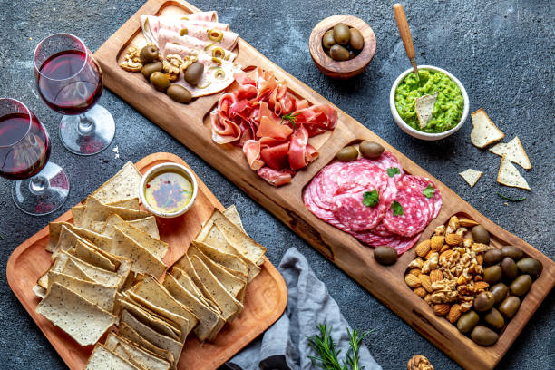 istock Antipasto Platter. Ham serrano, salami olive jamon dip sauces and red wine 1142520421