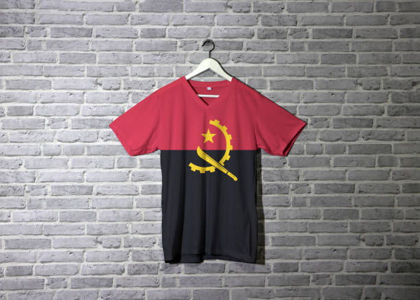 Angola flag on shirt and hanging on the wall with brick pattern wallpaper.