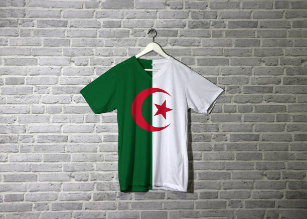 istock Algeria flag on shirt and hanging on the wall with brick pattern wallpaper. 1142521203